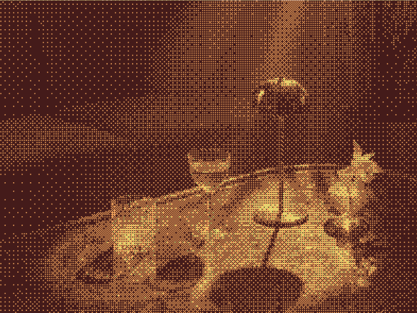 A dining table set with glassware, tableware, and decorative lighting.
